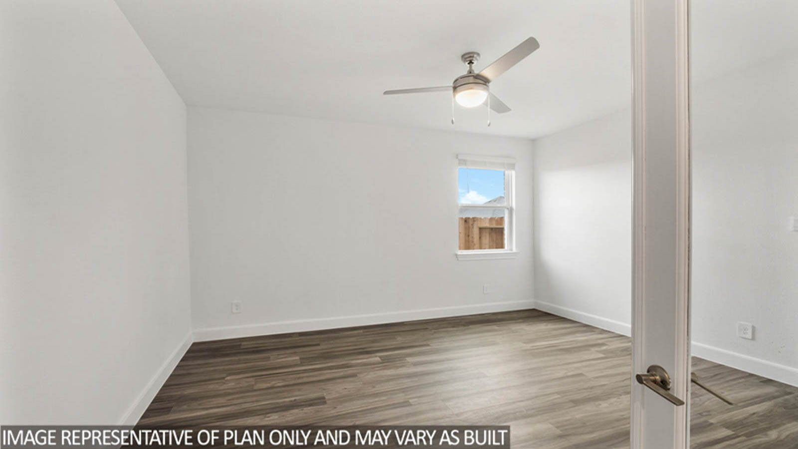 Secondary bedroom with vinyl flooring and a bright window.