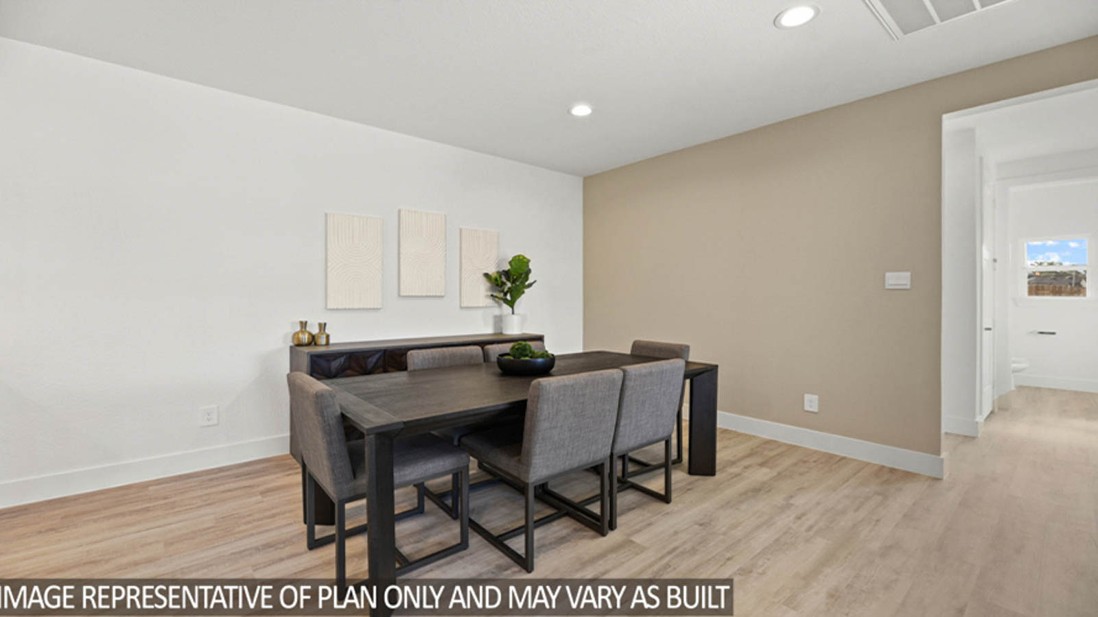 Breakfast area with vinyl flooring and a bright window.