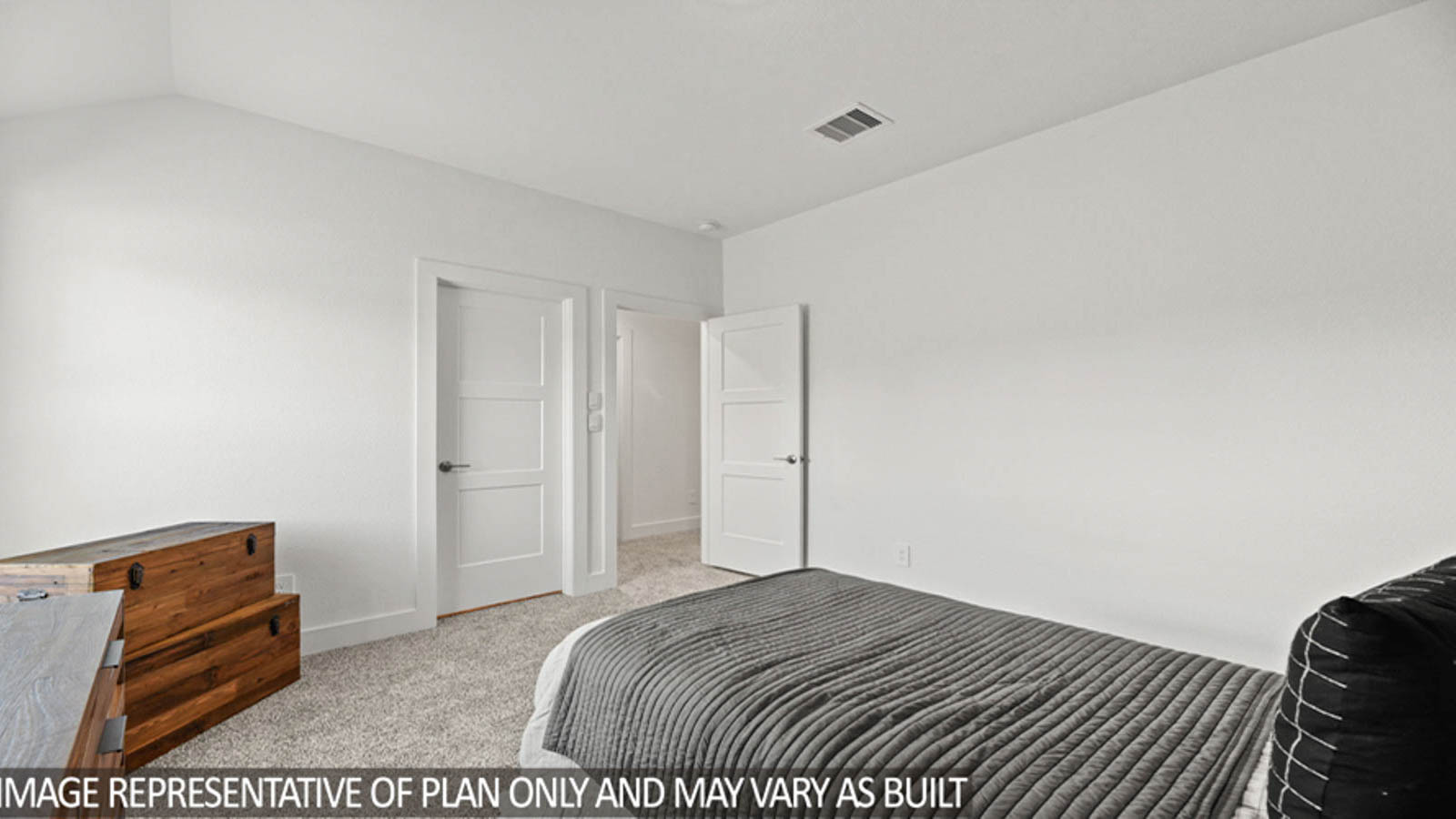 Secondary bedroom with carpet flooring and a bright window.