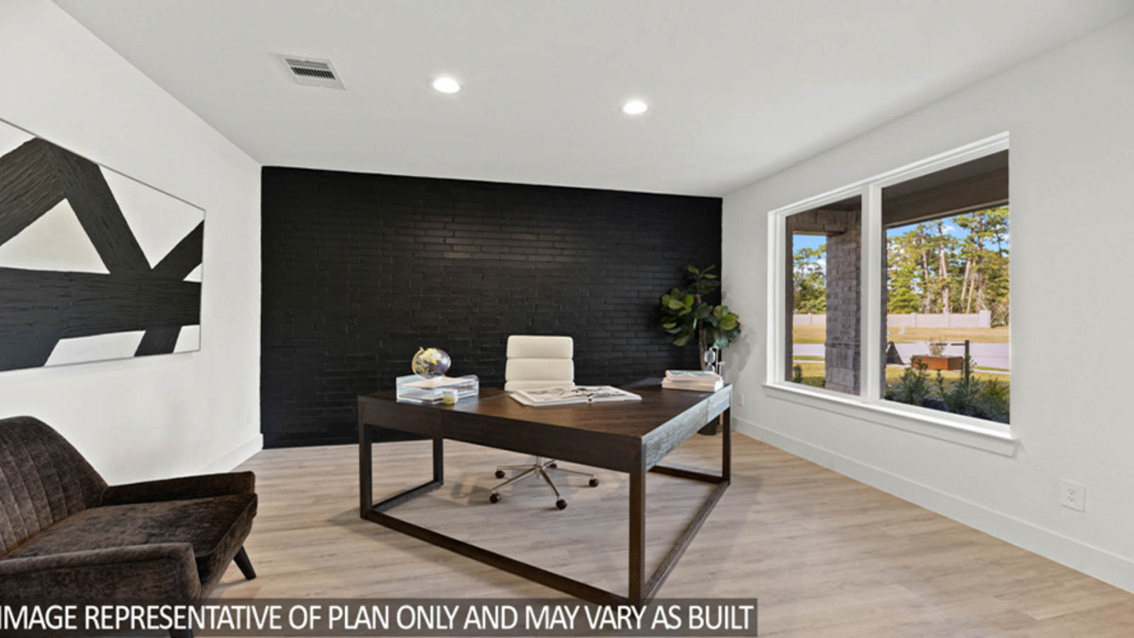 Dining room with vinyl flooring and bright windows.