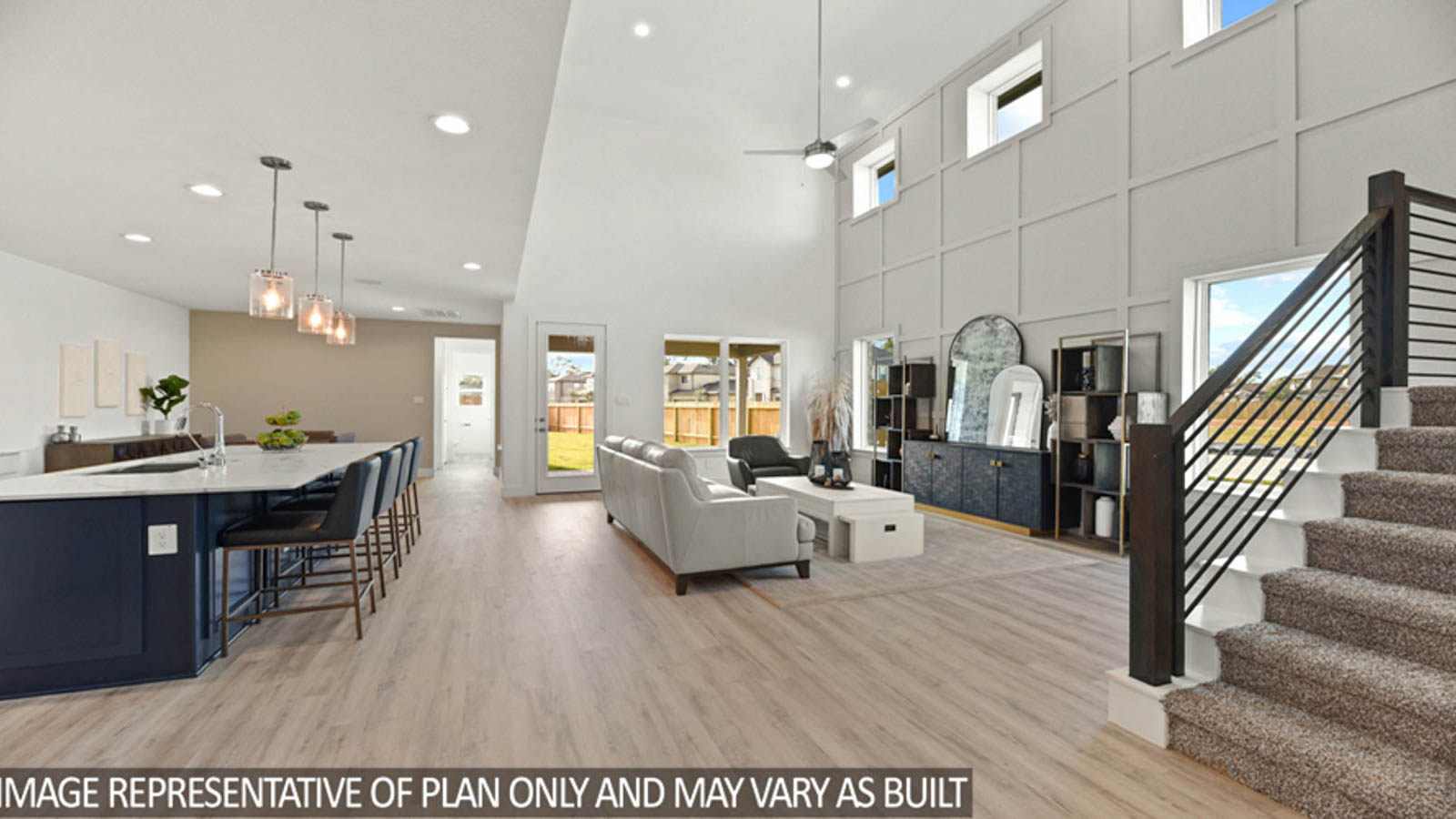 Open concept living and dining area with vinyl flooring and bright windows.