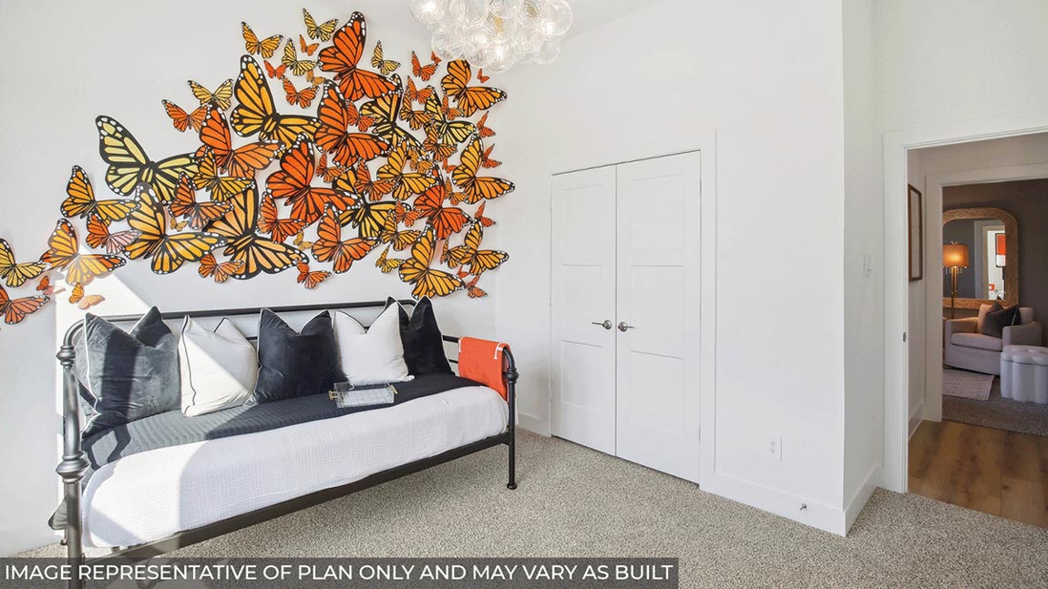 Secondary bedroom with carpet flooring