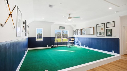 Game room decorated with putting green