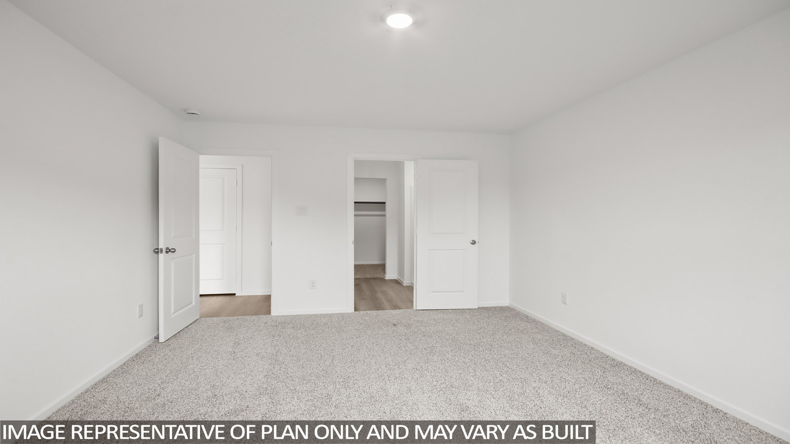 Primary bedroom with carpet flooring