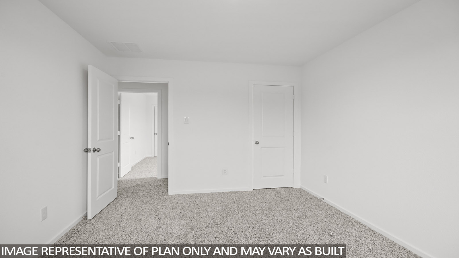 Secondary bedroom with carpet flooring