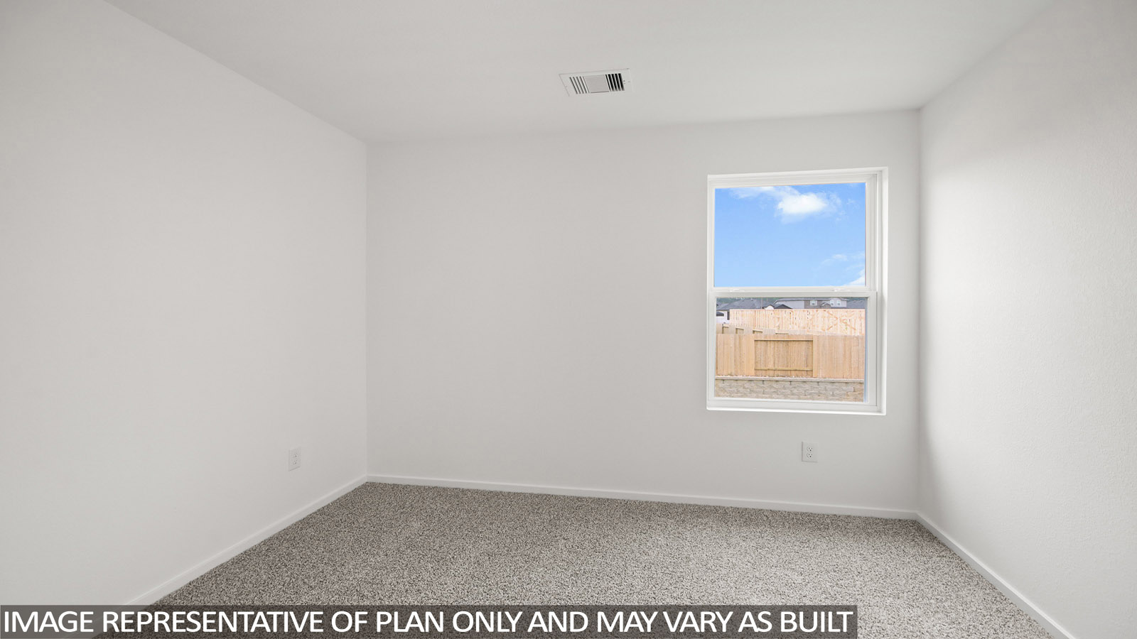 Secondary bedroom with carpet flooring