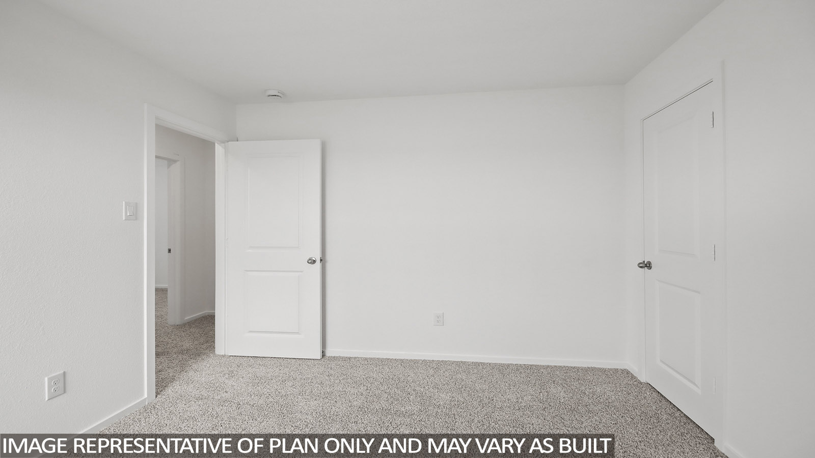 Secondary bedroom with carpet flooring