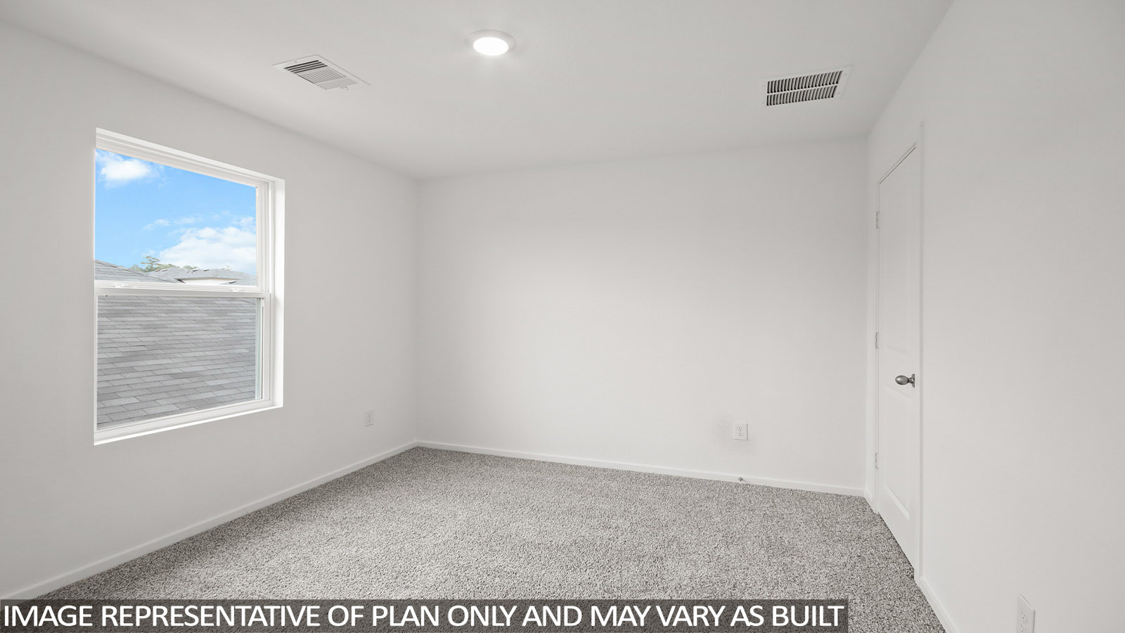 Secondary bedroom with carpet flooring