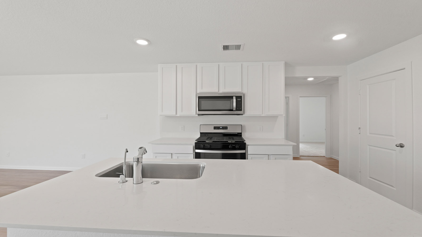 Kitchen with an island and stainless-steel appliances.
