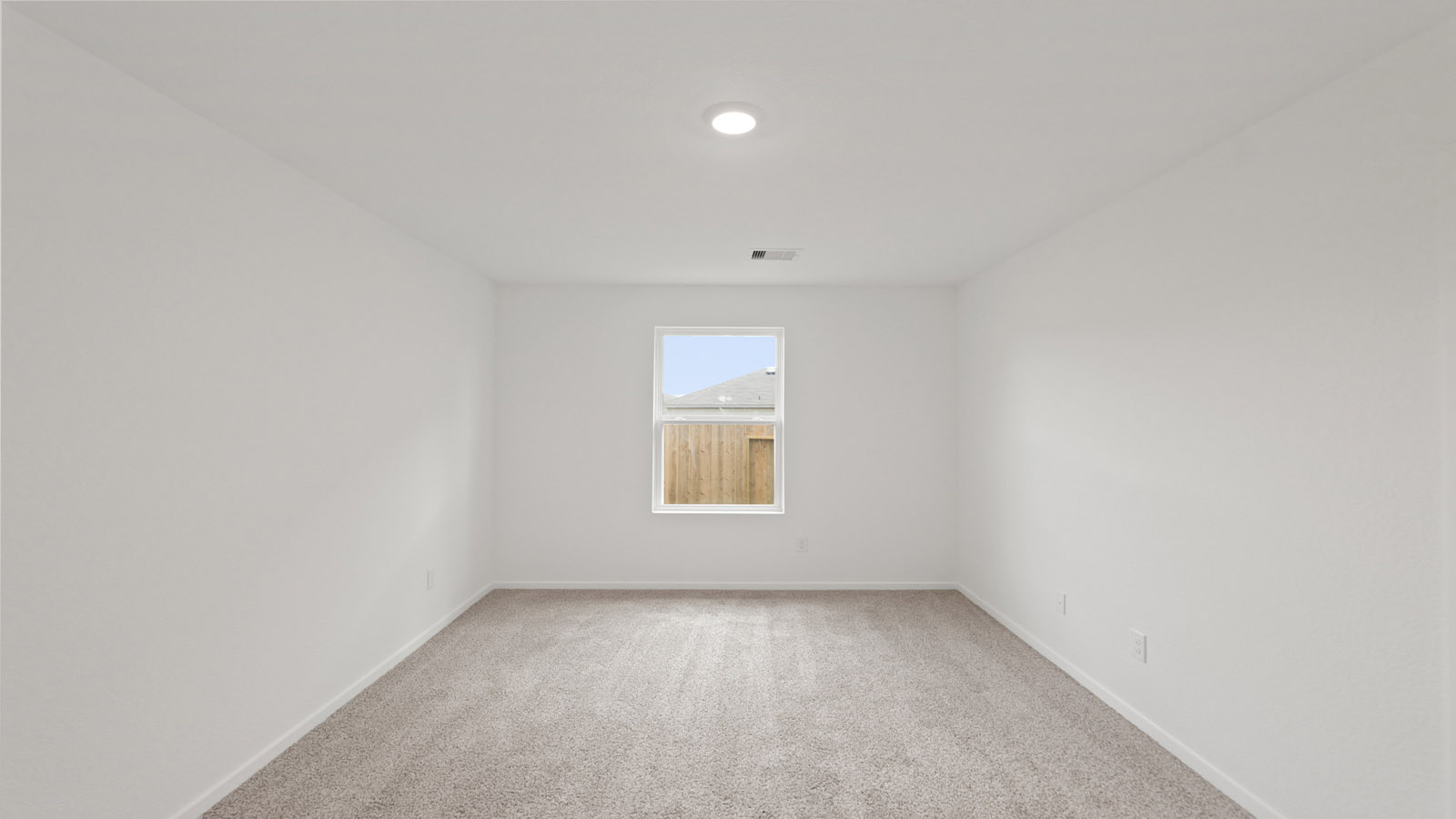 Secondary bedroom with carpet flooring and a bright window.