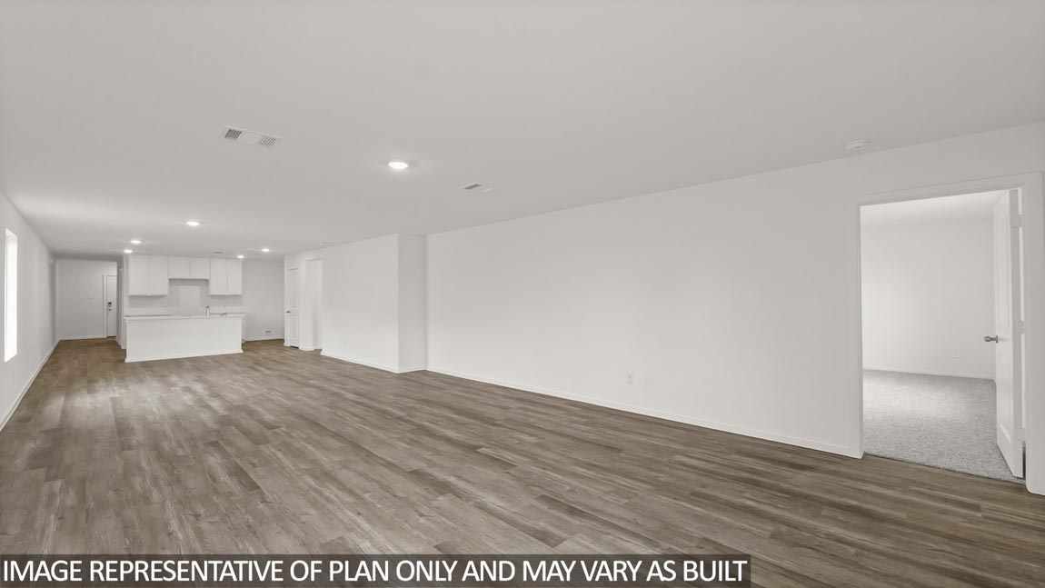 Open concept living and dining area with vinyl flooring and bright windows.