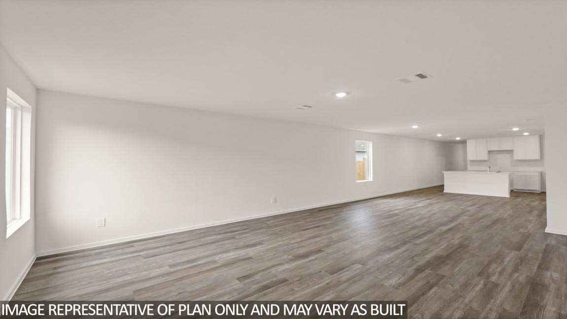 Open concept living and dining area with vinyl flooring and bright windows.