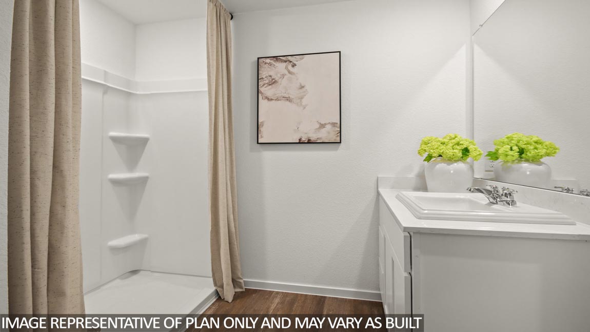 Primary bathroom iwth a standing shower and a double sink.