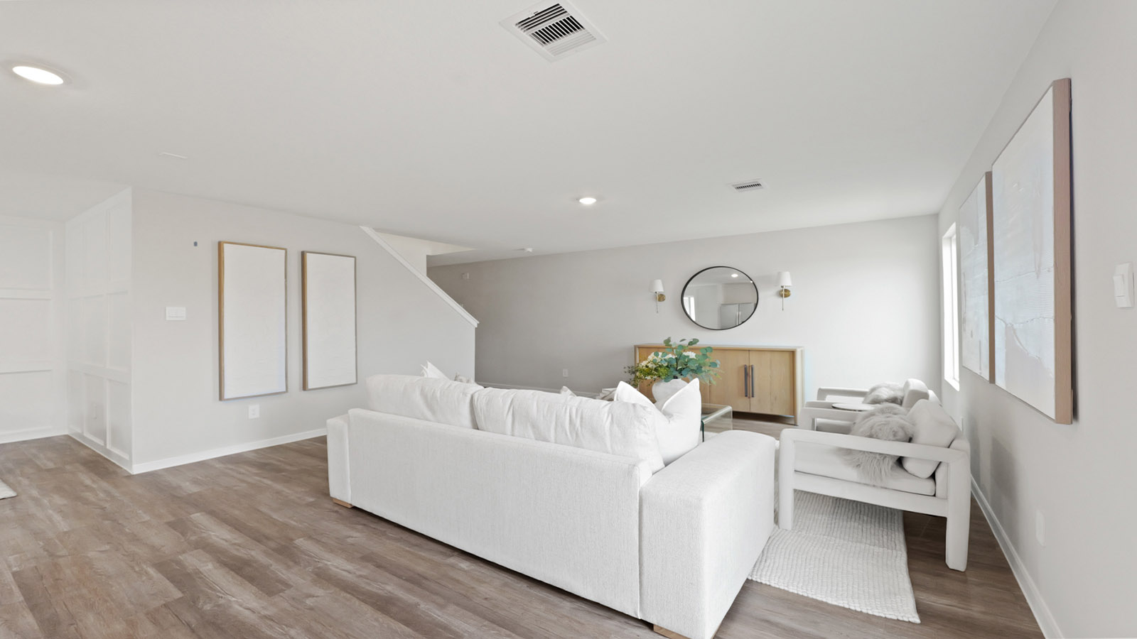 Living area with vinyl flooring and bright windows.