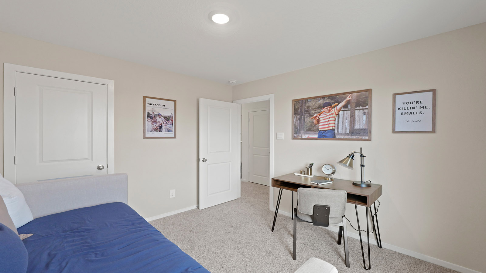 Secondary bedroom with carpet flooring and a bright window.