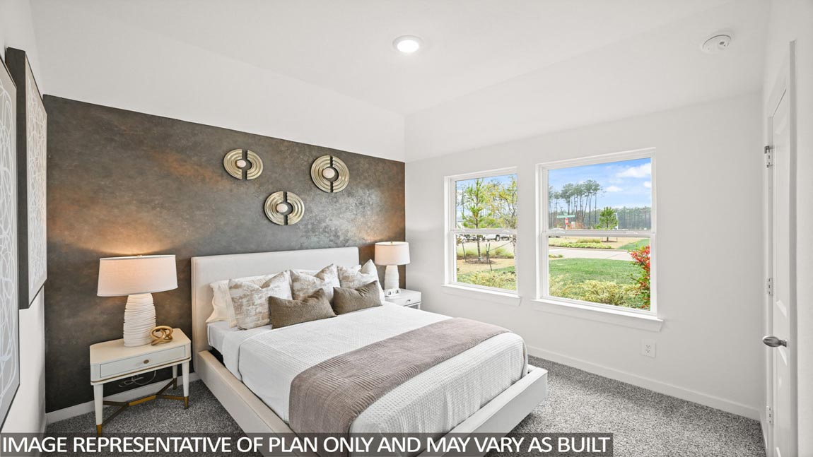 Secondary bedroom with carpet flooring