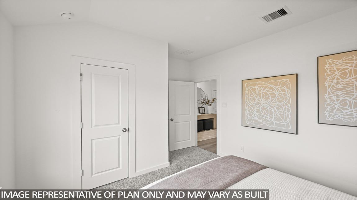 Secondary bedroom with carpet flooring