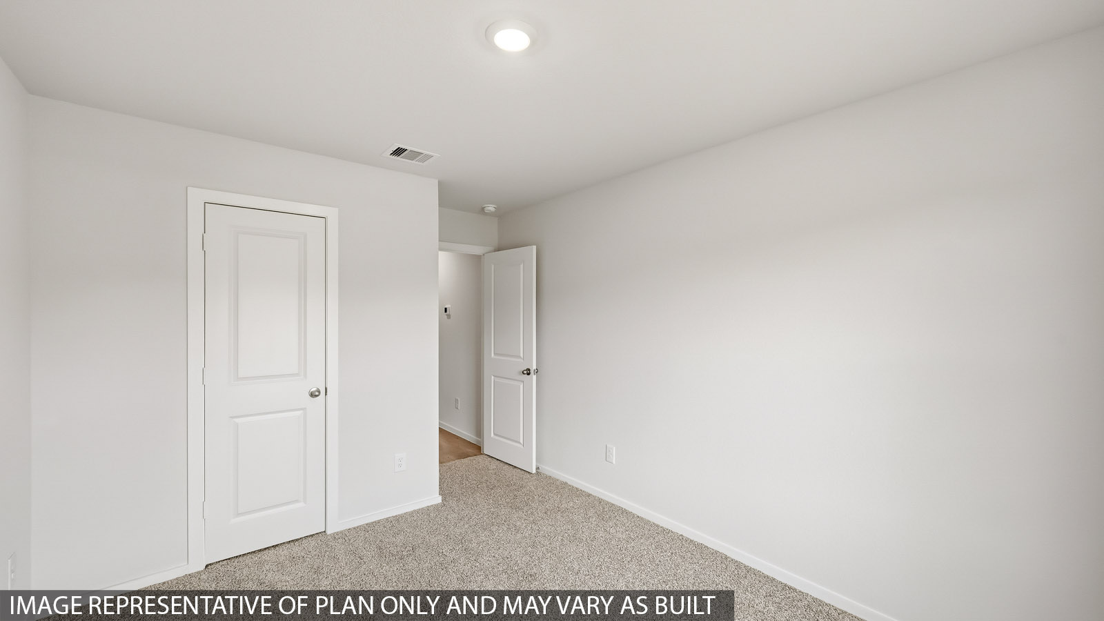 Secondary bedroom with carpet flooring