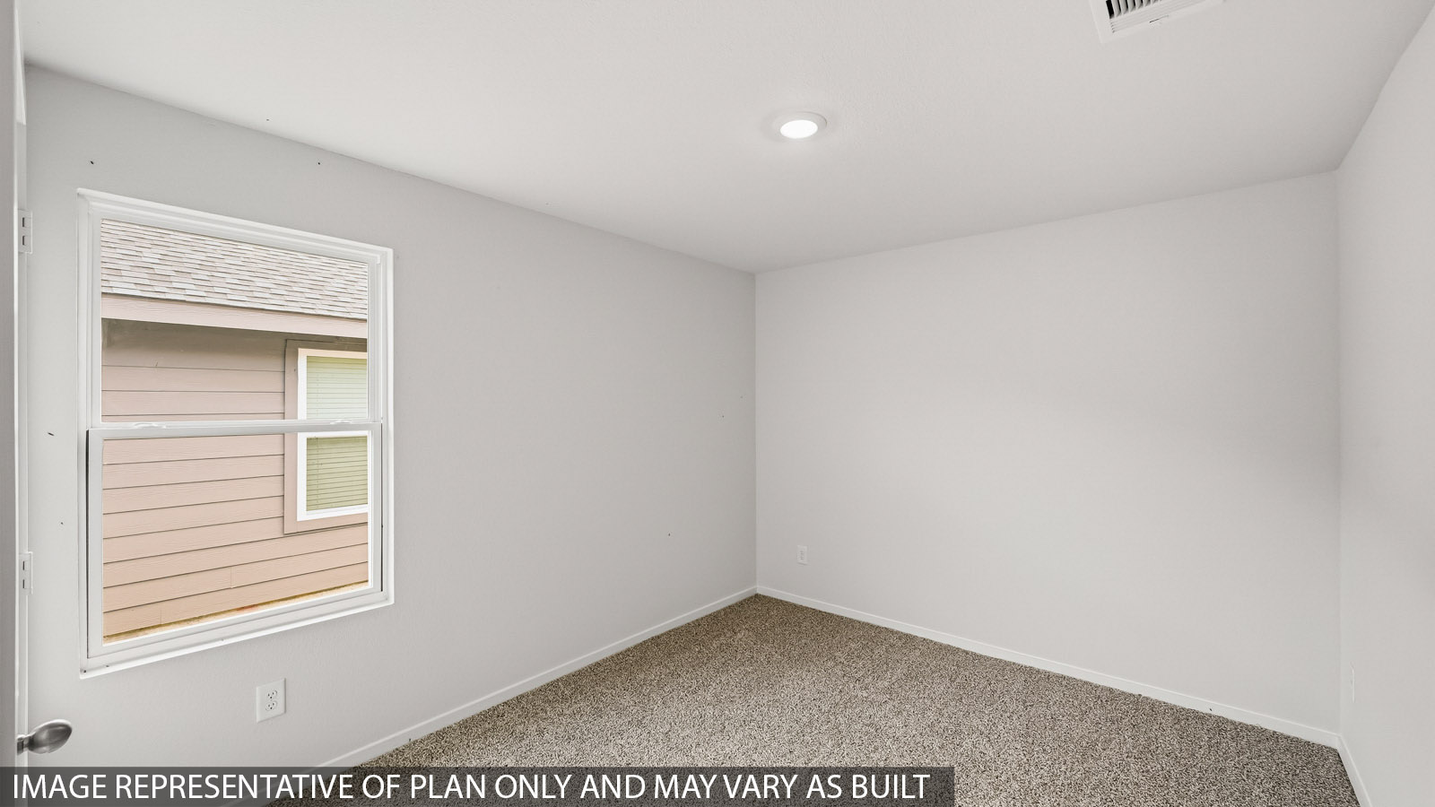 Secondary bedroom with carpet flooring