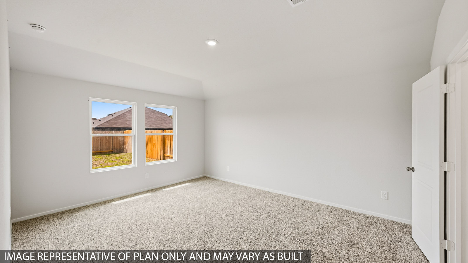 Primary bedroom with carpet flooring