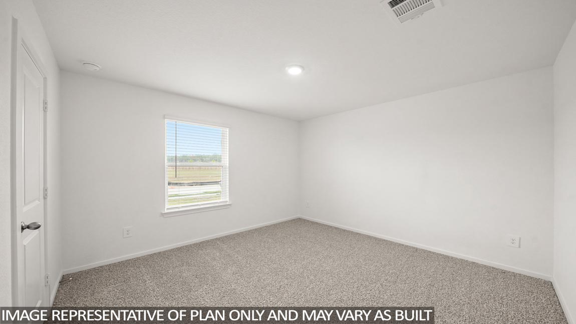 Secondary bedroom with carpet flooring