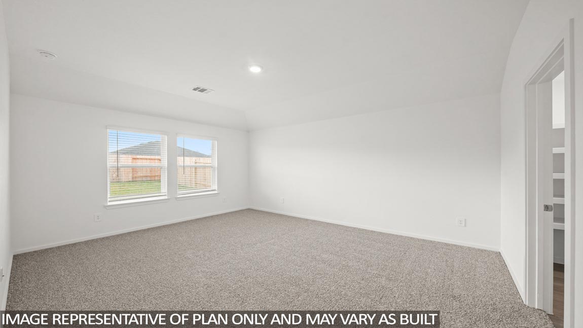 Primary bedroom with carpet flooring