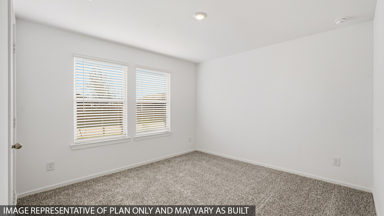 secondary bedroom with double windows at the front of the home