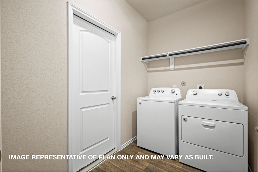 Utility room with overhead storage space.