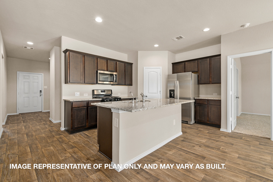 Kitchen with island and stainless-steel appliances.