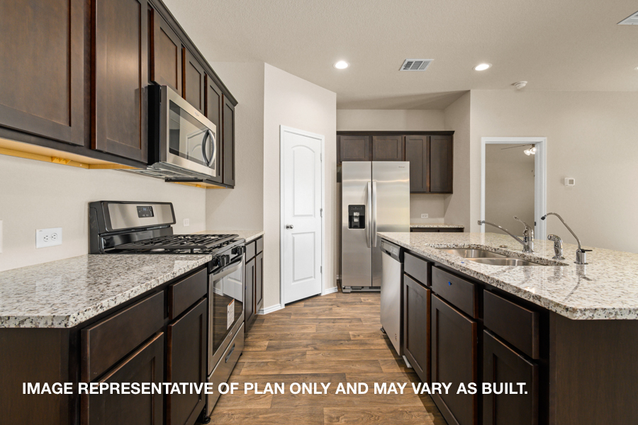 Kitchen with island and stainless-steel appliances.
