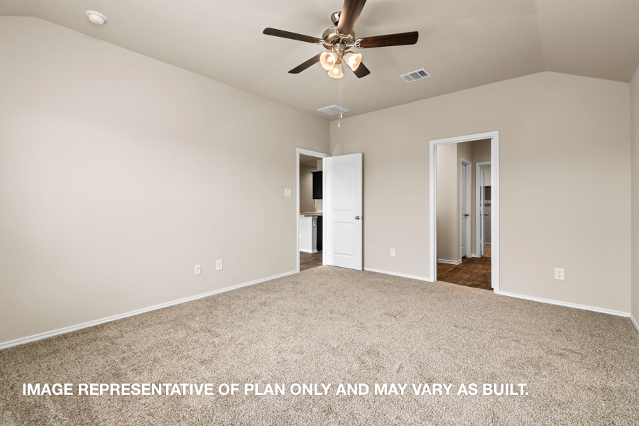 Primary bedroom with carpet flooring.