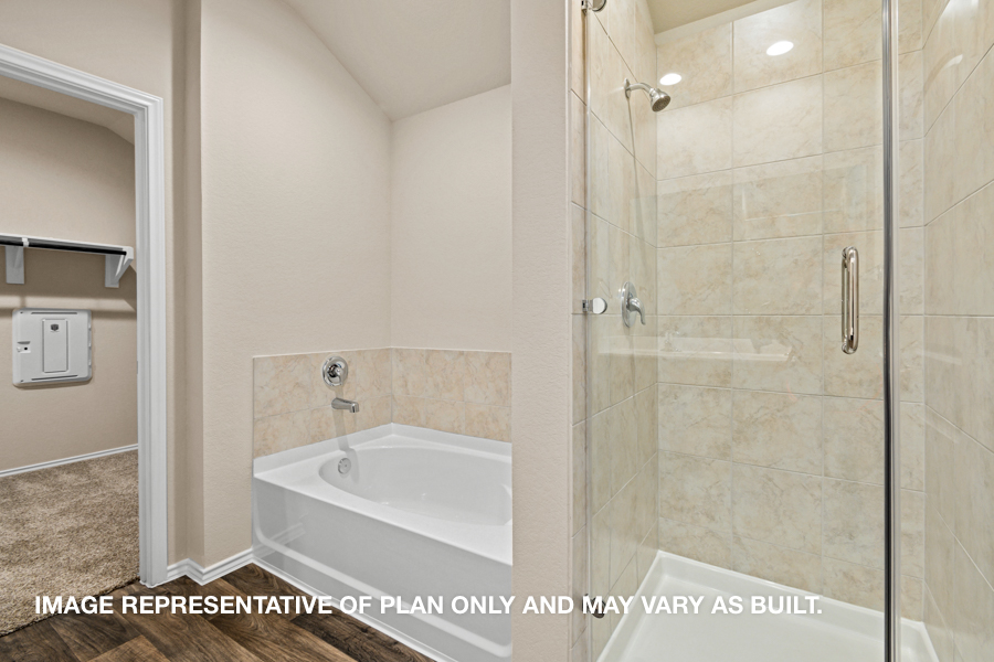 Primary bathroom with tile tub and standing shower.