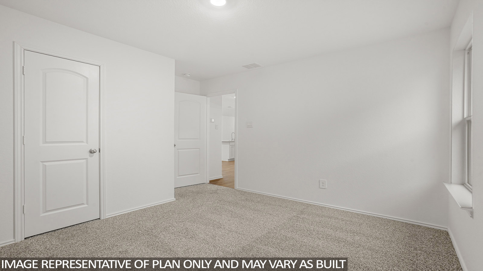 Secondary bedroom with carpet flooring and a tall closet.