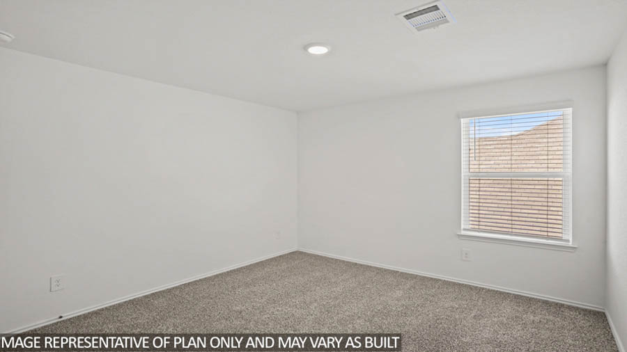 Secondary bedroom with carpet flooring and a bright window.