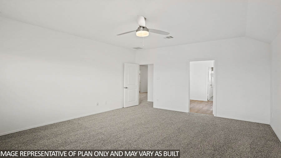 Primary bedroom with carpet flooring, bright windows, and a ceiling fan.