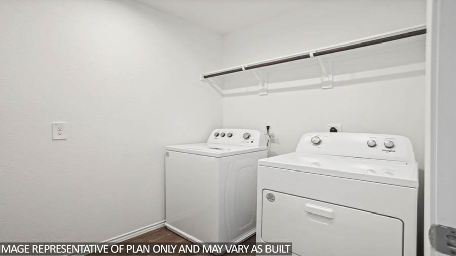 Utility room with vinyl flooring and overhead storage space.