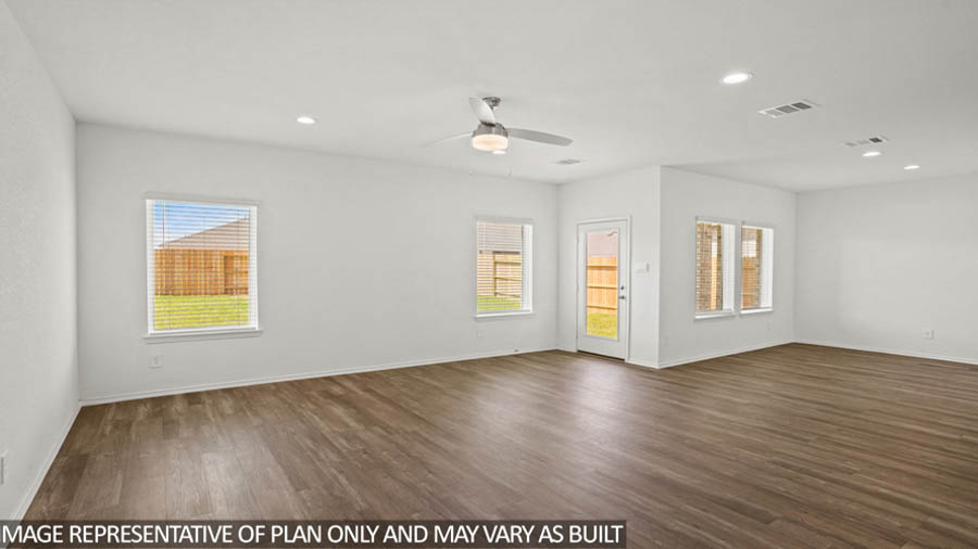 Open concept living and dining area with vinyl flooring and bright windows.