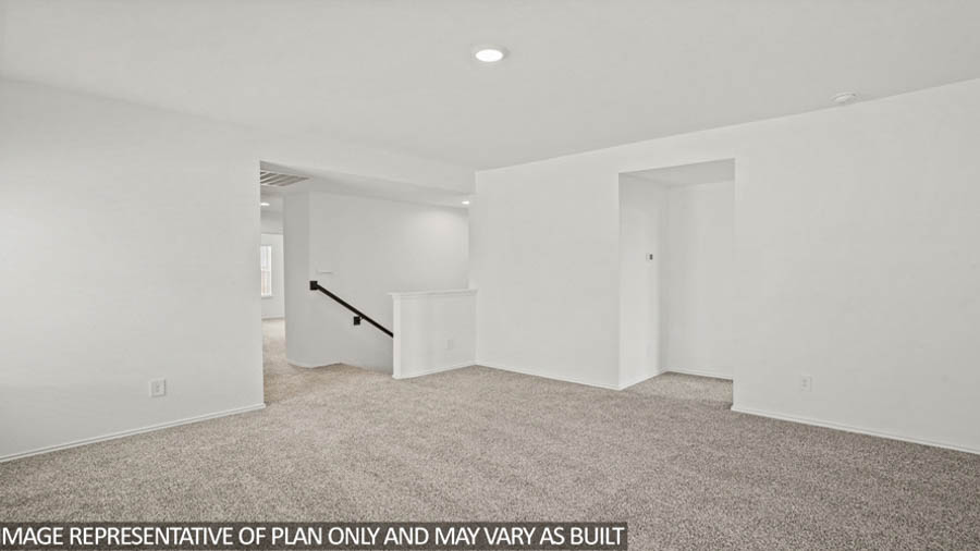 Upstairs game room with carpet flooring.
