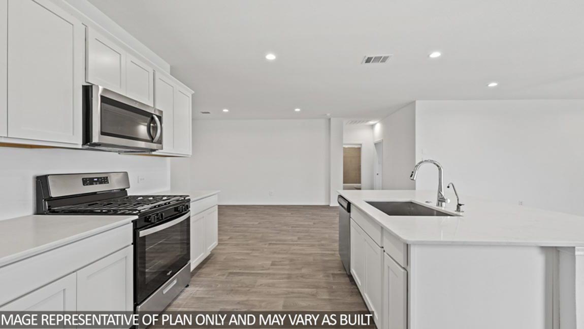 Kitchen with island and stainless-steel appliances.