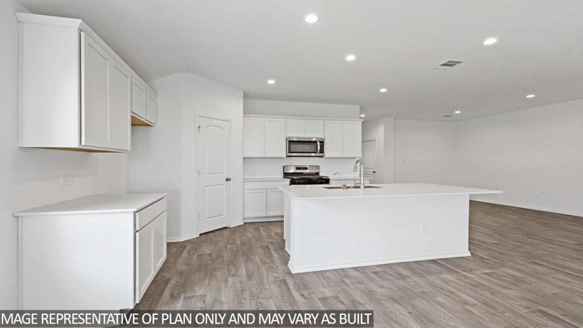 Kitchen with island and stainless-steel appliances.