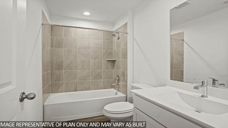 Secondary bathroom with a tile tub/shower combo.