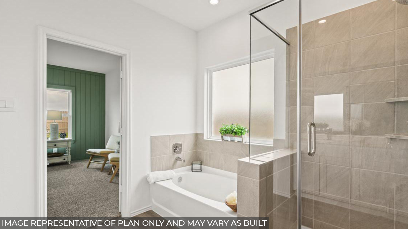 Primary bathroom with a frosted window, a tile tub, a standing shower, a separate toilet room, a walk-in closet, and a double sink.