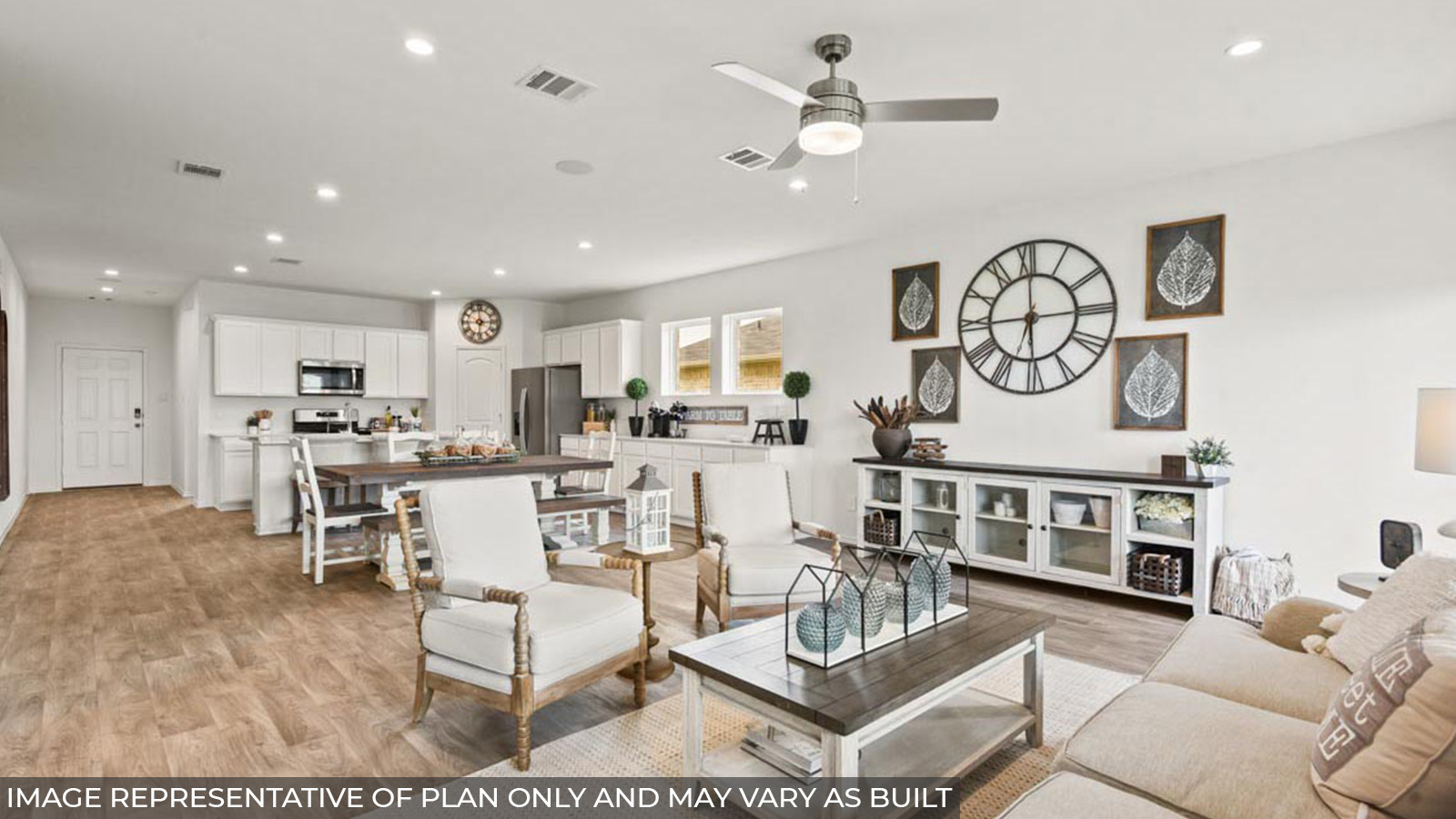 Open concept living and dining area with vinyl flooring and bright windows.
