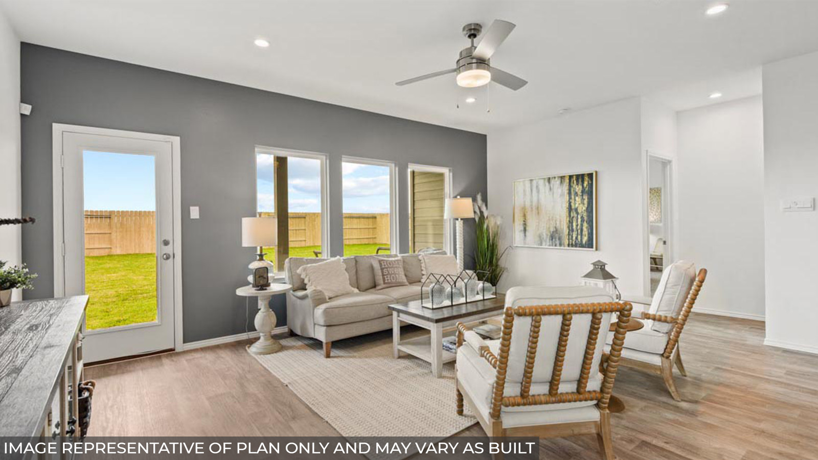 Open concept living and dining area with vinyl flooring and bright windows.