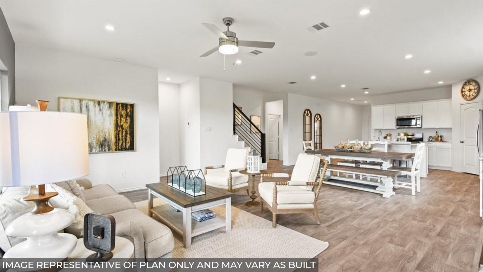Open concept living and dining area with vinyl flooring and bright windows.
