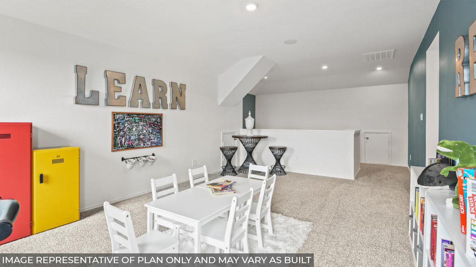 Upstairs game room with carpet flooring and bright windows.