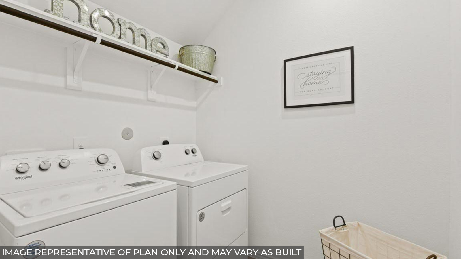 Utility room with vinyl flooring and overhead storage space.