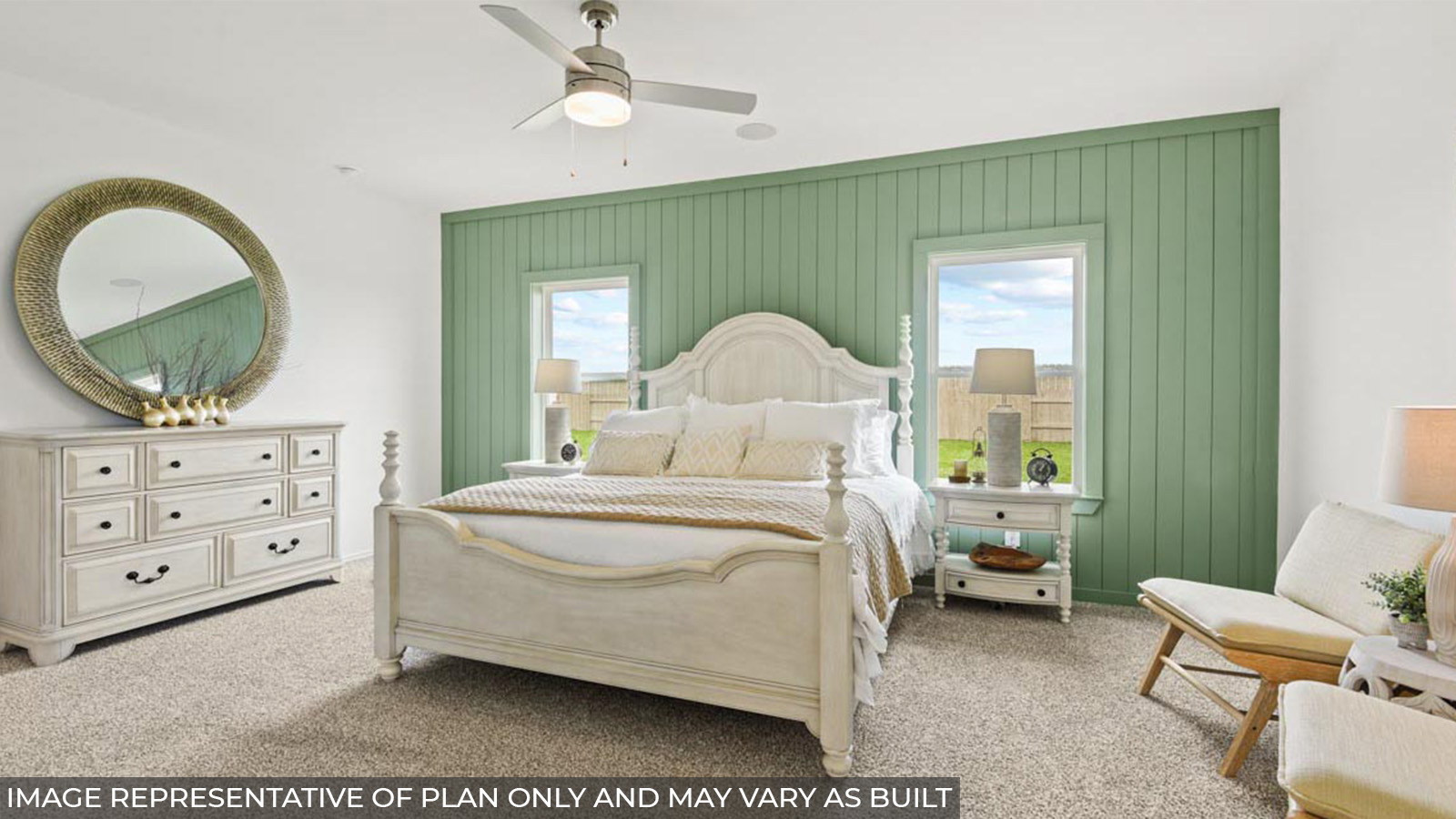 Primary bedroom with carpet flooring and bright windows.
