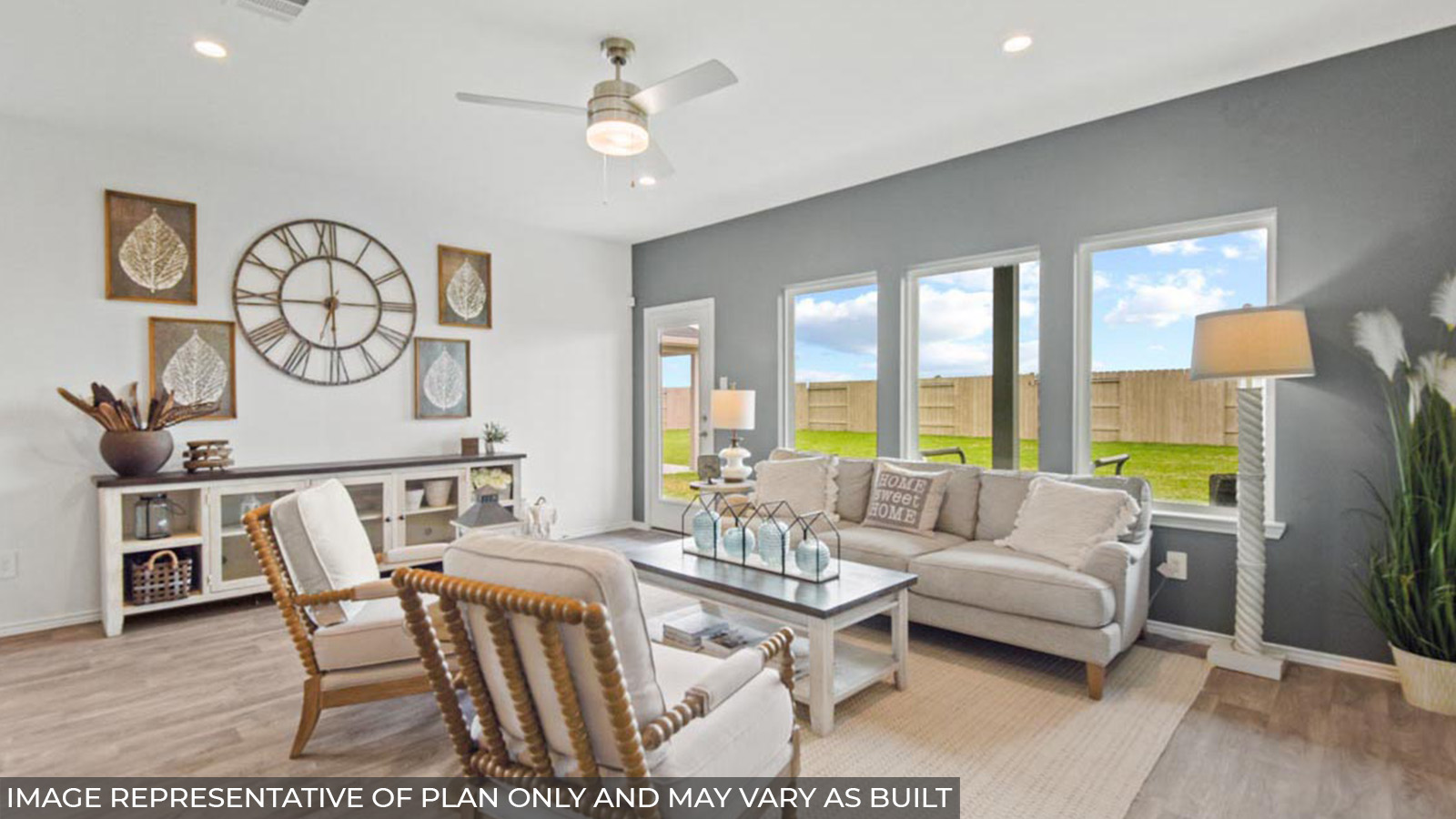 Open concept living and dining area with vinyl flooring and bright windows.