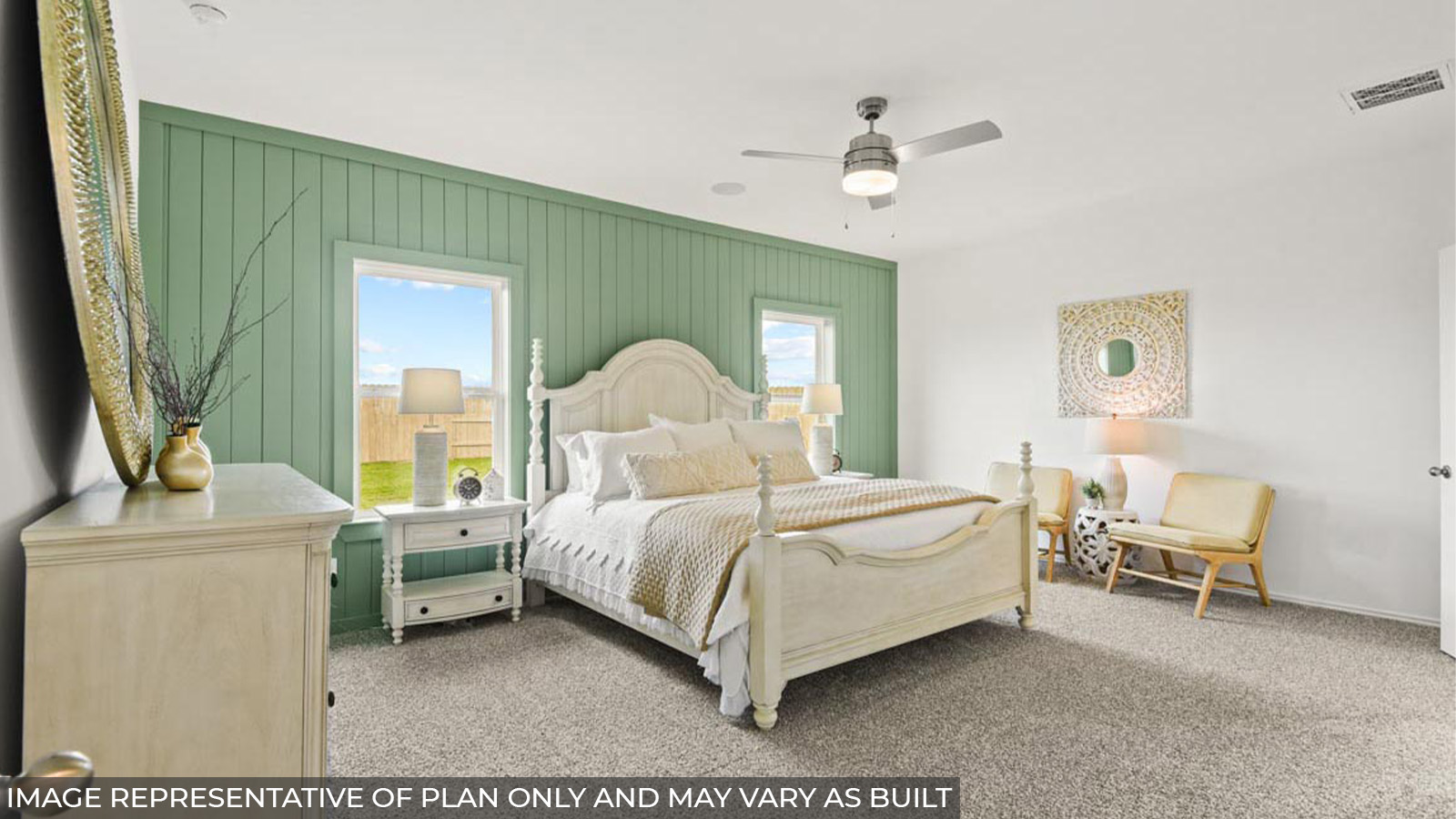 Primary bedroom with carpet flooring and bright windows.